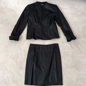 Black jacket and skirt, looks like leather but it is not. Jacket small, skirt 4.